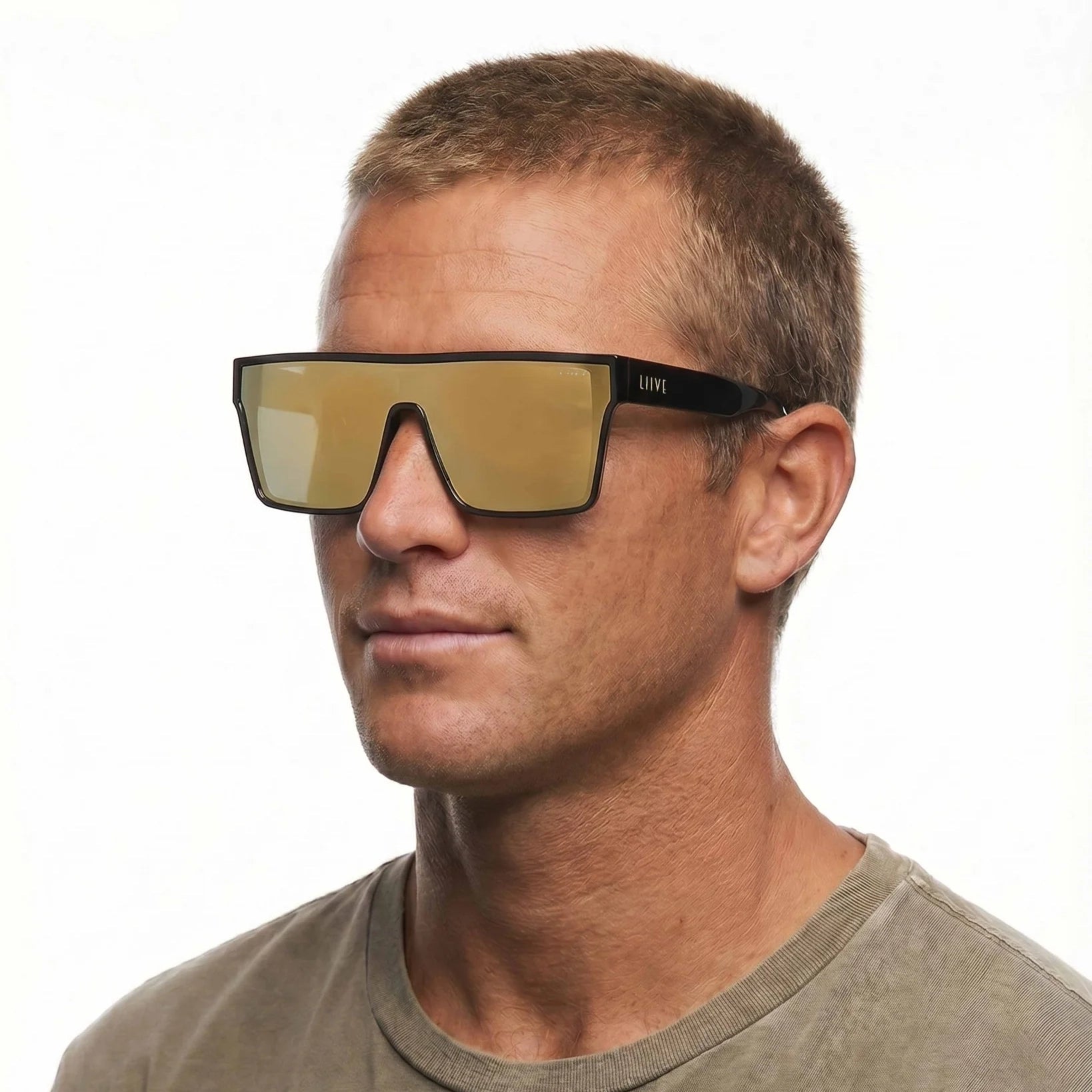 A headshot of a man modelling a pair of Black Liive Vision Wasteland Sunglasses (L0828C) with large mirror gold lenses and 'LIIVE' branding on the temple, shown on a white background.