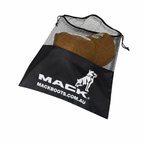 A black drawstring Mack Mesh Promo Bag with white Mack Boots branding, containing a cap, shown on a plain white background.