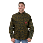 A man wearing a long-sleeve button-up shirt with an all-over dark olive green and black pattern, featuring a red circular logo patch on the chest, paired with blue jeans against a white background.