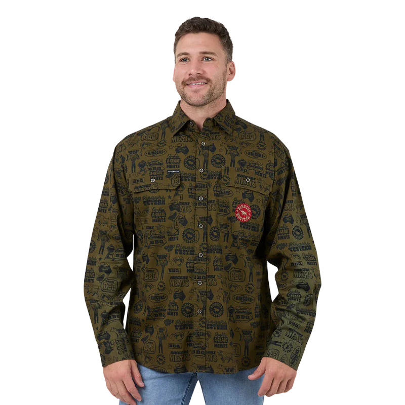 A man wearing a long-sleeve button-up shirt with an all-over dark olive green and black pattern, featuring a red circular logo patch on the chest, paired with blue jeans against a white background.