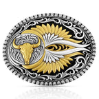 The Montana Silversmiths Sturgis Attitude Buckle (A1039P) features a gold buffalo skull motif, stylized gold and silver feathered wings on black, and detailed silver scrollwork along the edges.