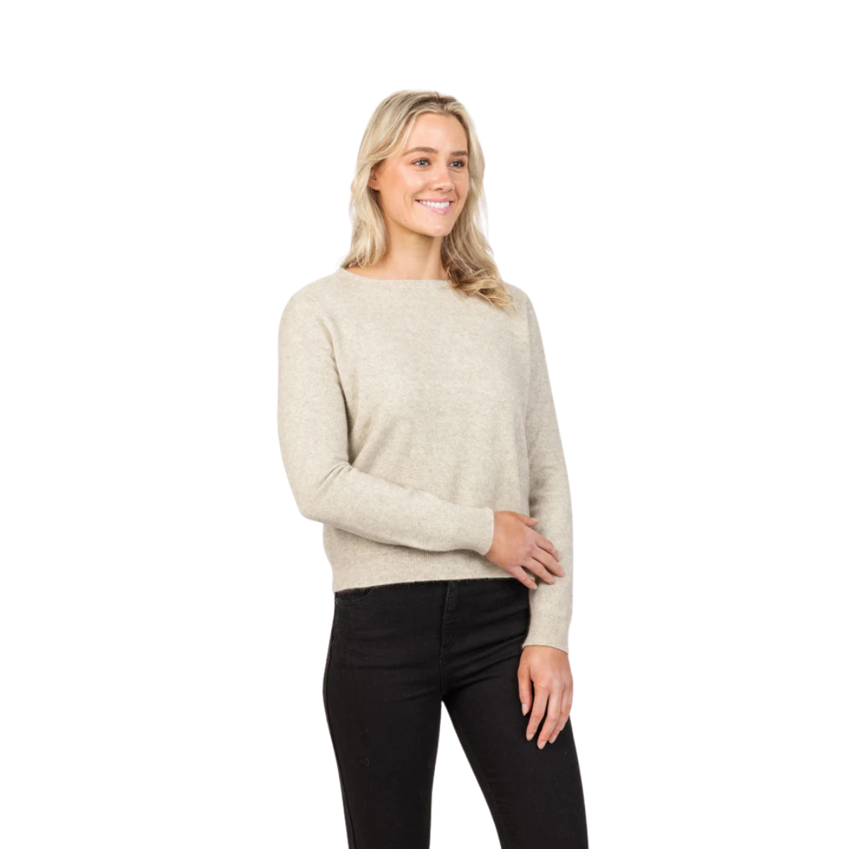 A woman with long blonde hair wears the Native World Womens Classic Crop Sweater (NB870) in Natural, paired with black pants, smiling against a plain white background.