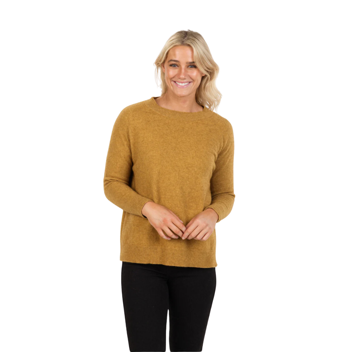 A smiling woman with blonde hair wears the Native World Womens Lounge Sweater (NB816) in Marigold and black pants, standing against a plain white background. Made in New Zealand.