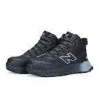 3-4 front view of a pair of black and grey New Balance Men's Cremorne Mid Cut Safety Sneakers (MEFCMCAPBG) with logos on a white background.