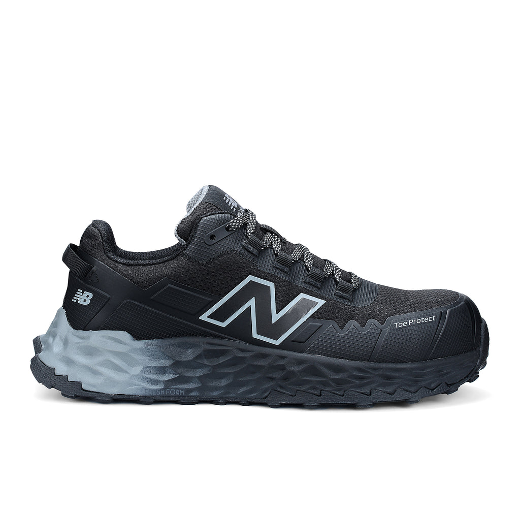 Side view of a black and grey New Balance Men's Cremorne Safety Sneaker (MEFCCAPBG) on a white background.