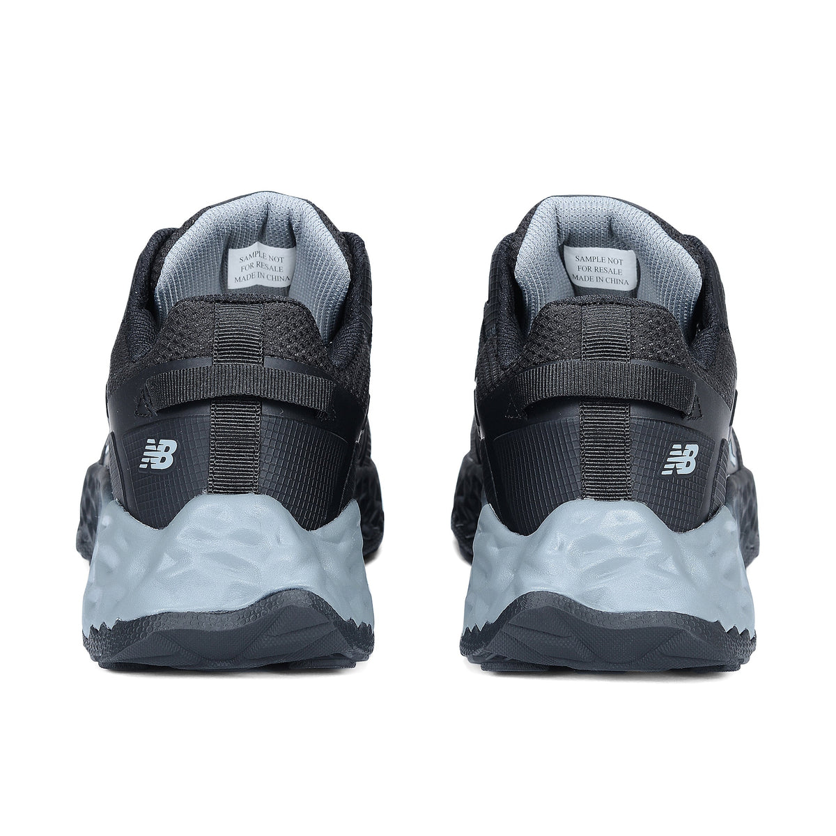 Heel view of a pair of black and grey New Balance Men's Cremorne Safety Sneakers (MEFCCAPBG) on a white background.