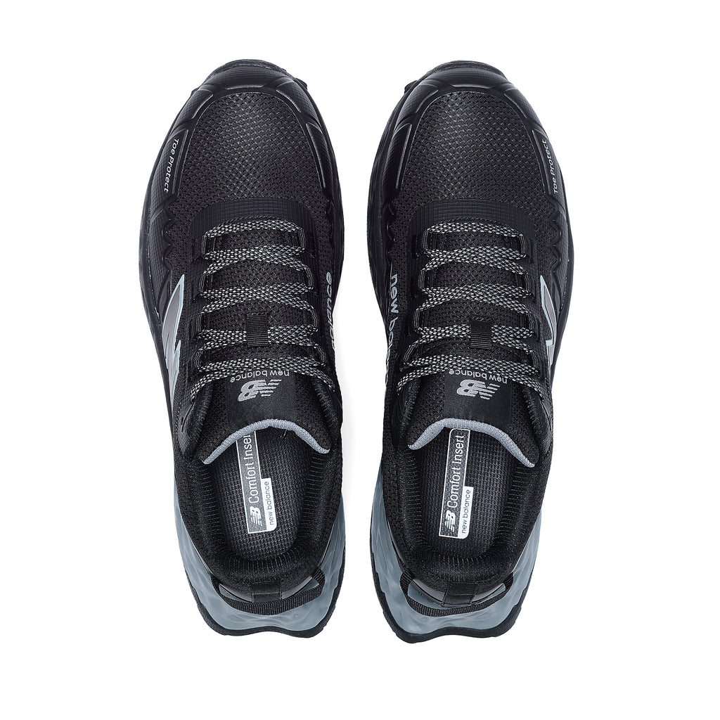 Top view of a pair of black and grey New Balance Men's Cremorne Safety Sneakers (MEFCCAPBG) on a white background.