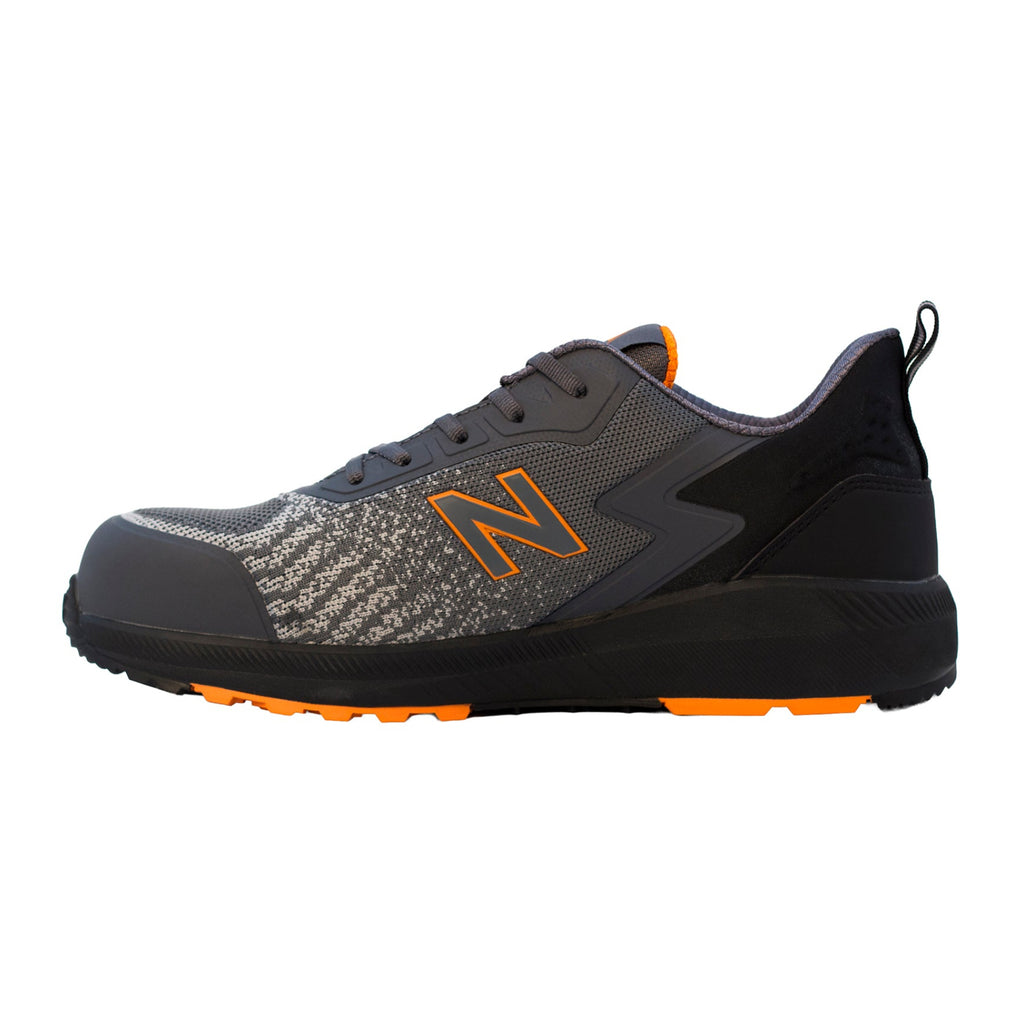 Side view of a grey and orange New Balance Men's Speedware Composite Toe Sneaker (MIDSPWR) with logo detail on a white background.