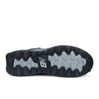 Sole view of a black and grey New Balance Women's Cremorne Mid Cut Safety Sneaker (WEFCMCAPBG) with New Balance logos on a white background.
