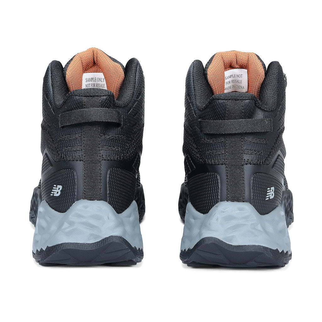 Heel view of a pair of black and grey New Balance Women's Cremorne Mid Cut Safety Sneakers (WEFCMCAPBG) with New Balance logos on a white background.