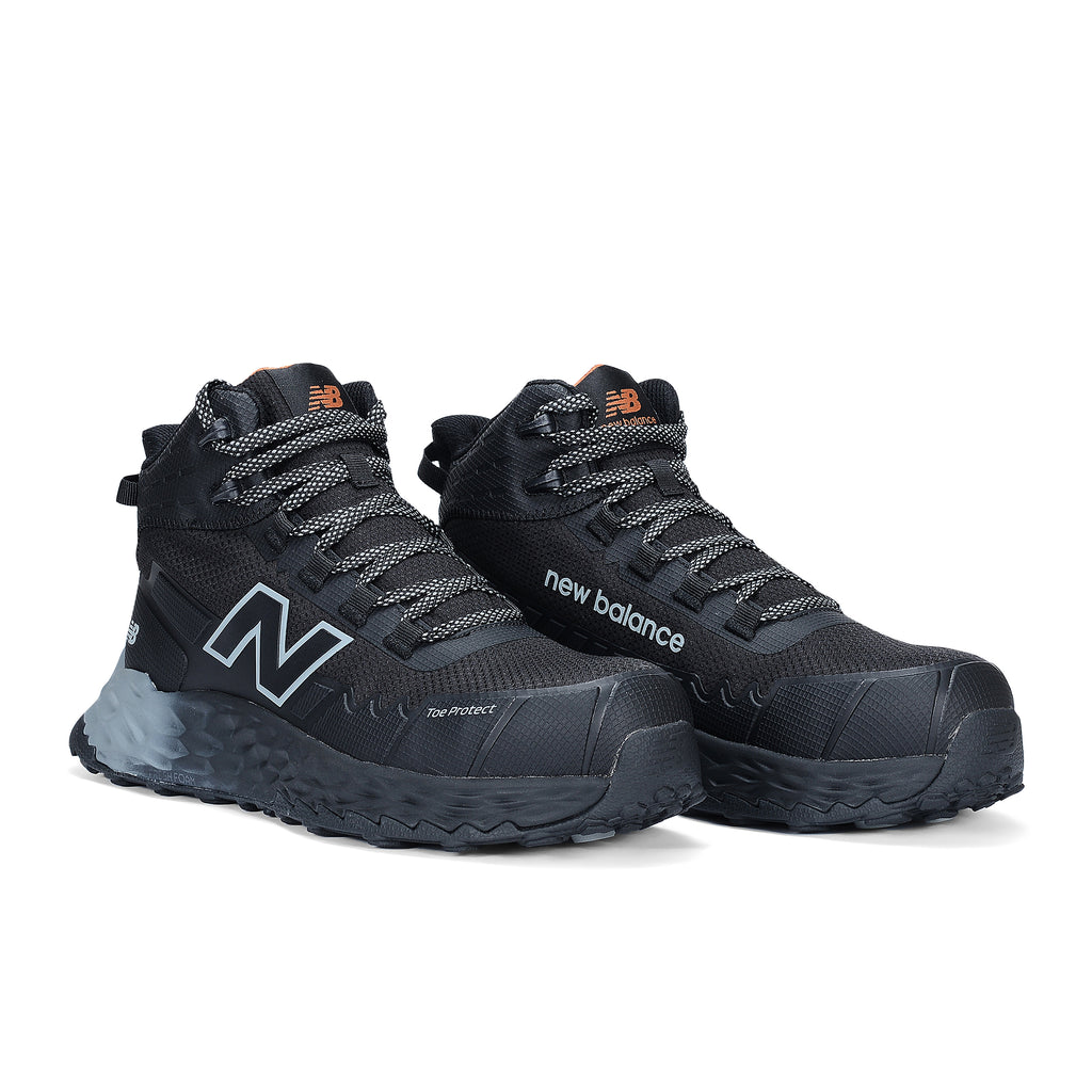 3-4 front view of a pair of black and grey New Balance Women's Cremorne Mid Cut Safety Sneakers (WEFCMCAPBG) with New Balance logos on a white background.