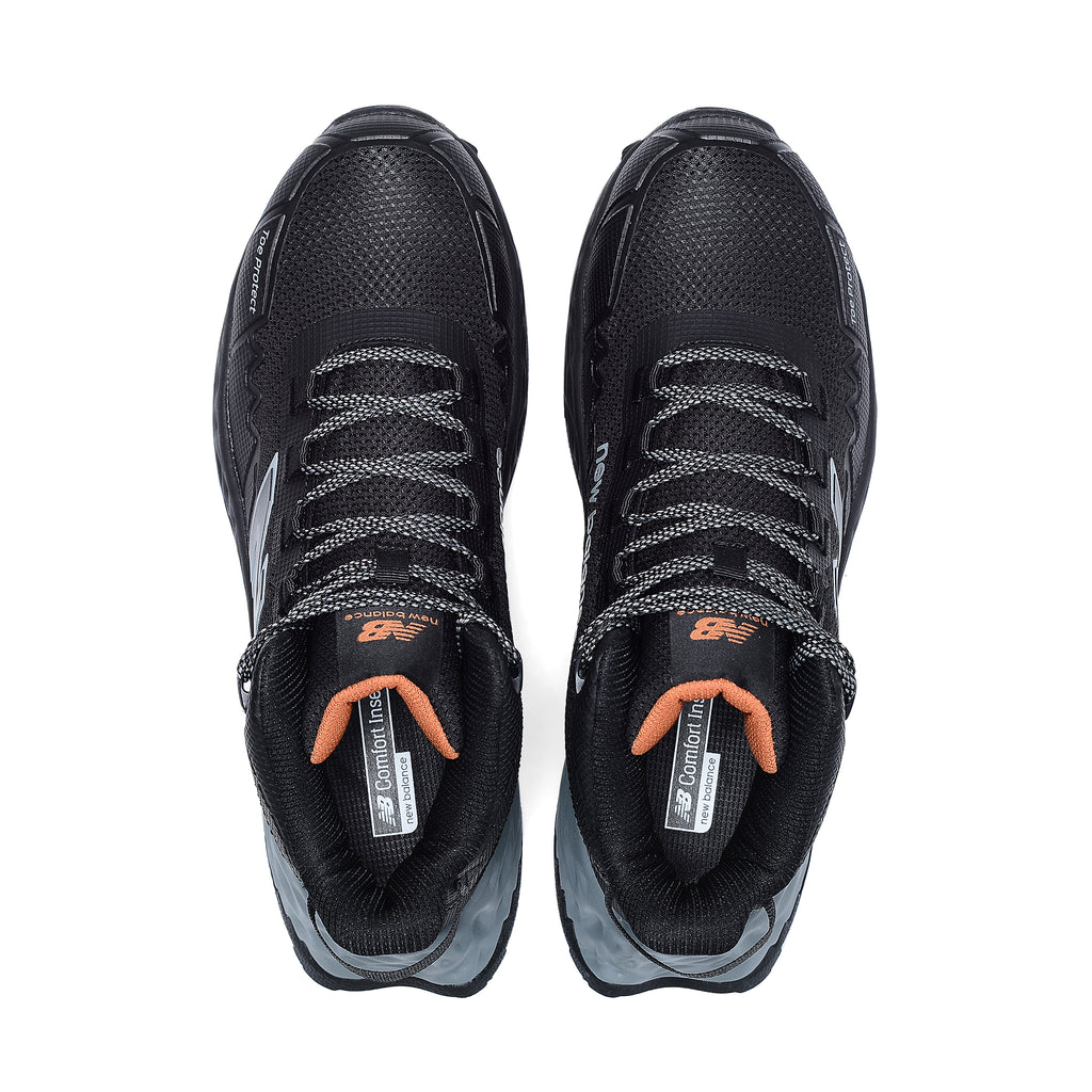 Top view of a pair of black and grey New Balance Women's Cremorne Mid Cut Safety Sneakers (WEFCMCAPBG) with New Balance logos on a white background.