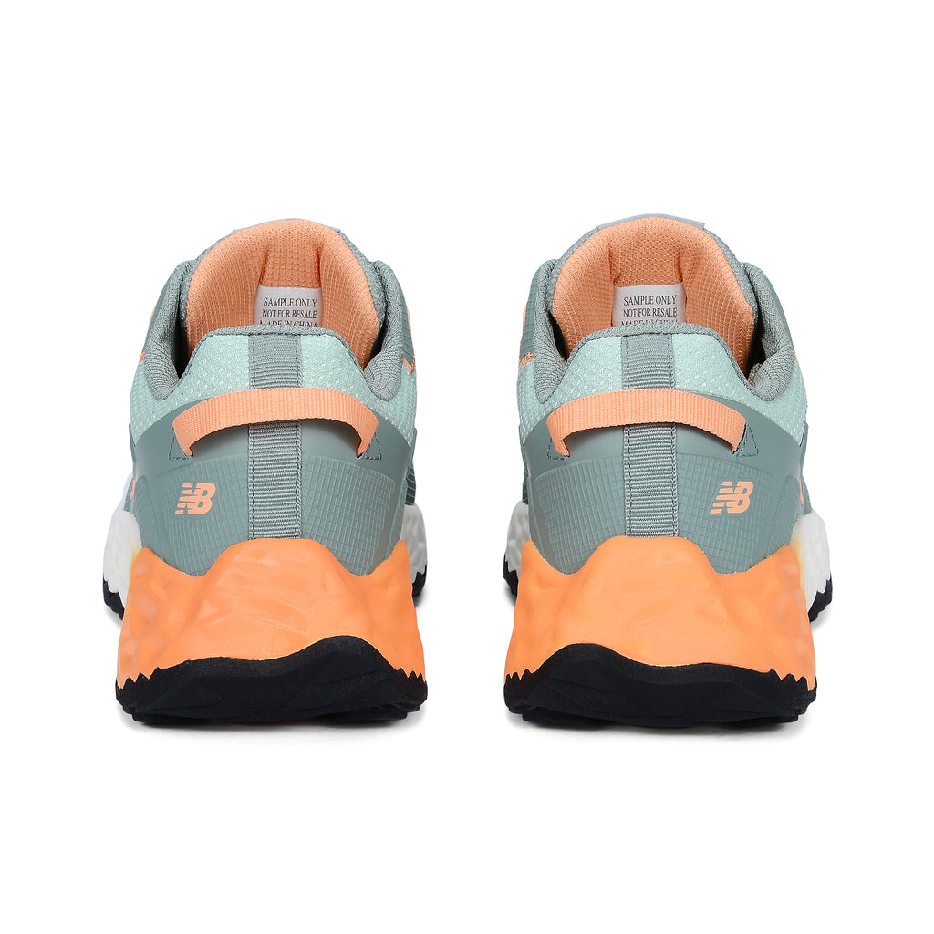 Heel view of a pair of aqua and pumpkin New Balance Women's Cremorne Safety Sneaker (WEFCCAPAP) with New Balance logo on a white background.