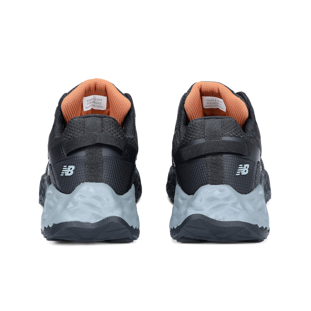 Heel view of a pair of black and grey New Balance Women's Cremorne Safety Sneaker (WEFCCAPBG) with New Balance logo on a white background.