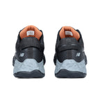 Heel view of a pair of black and grey New Balance Women's Cremorne Safety Sneaker (WEFCCAPBG) with New Balance logo on a white background.