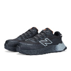 3-4 front view of a pair of black and grey New Balance Women's Cremorne Safety Sneaker (WEFCCAPBG) with New Balance logo on a white background.