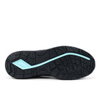 Sole view of a black/blue New Balance Women's Logic Composite Toe Shoe (WIDLOGI) with logos on a white background.