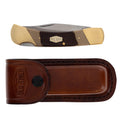 An Old Timer Cave Bear Knife with Leather Pouch (7OT) with a satin finish steel blade, tan and dark brown handle scales, brass bolsters and brass pins, shown above its matching brown leather sheath on a white background.