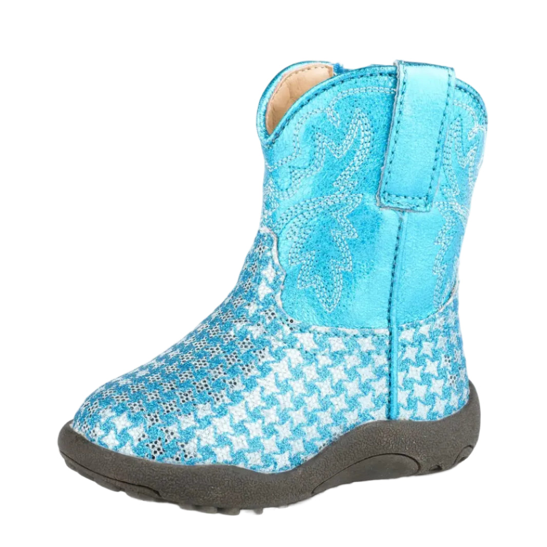 The Roper Infants Cowbaby Glitter Gleam Western Boot (16901497) in blue features a metallic finish, houndstooth pattern, decorative stitching, wide square toe, pull tab, and a black rubber sole. Shown against a white background.
