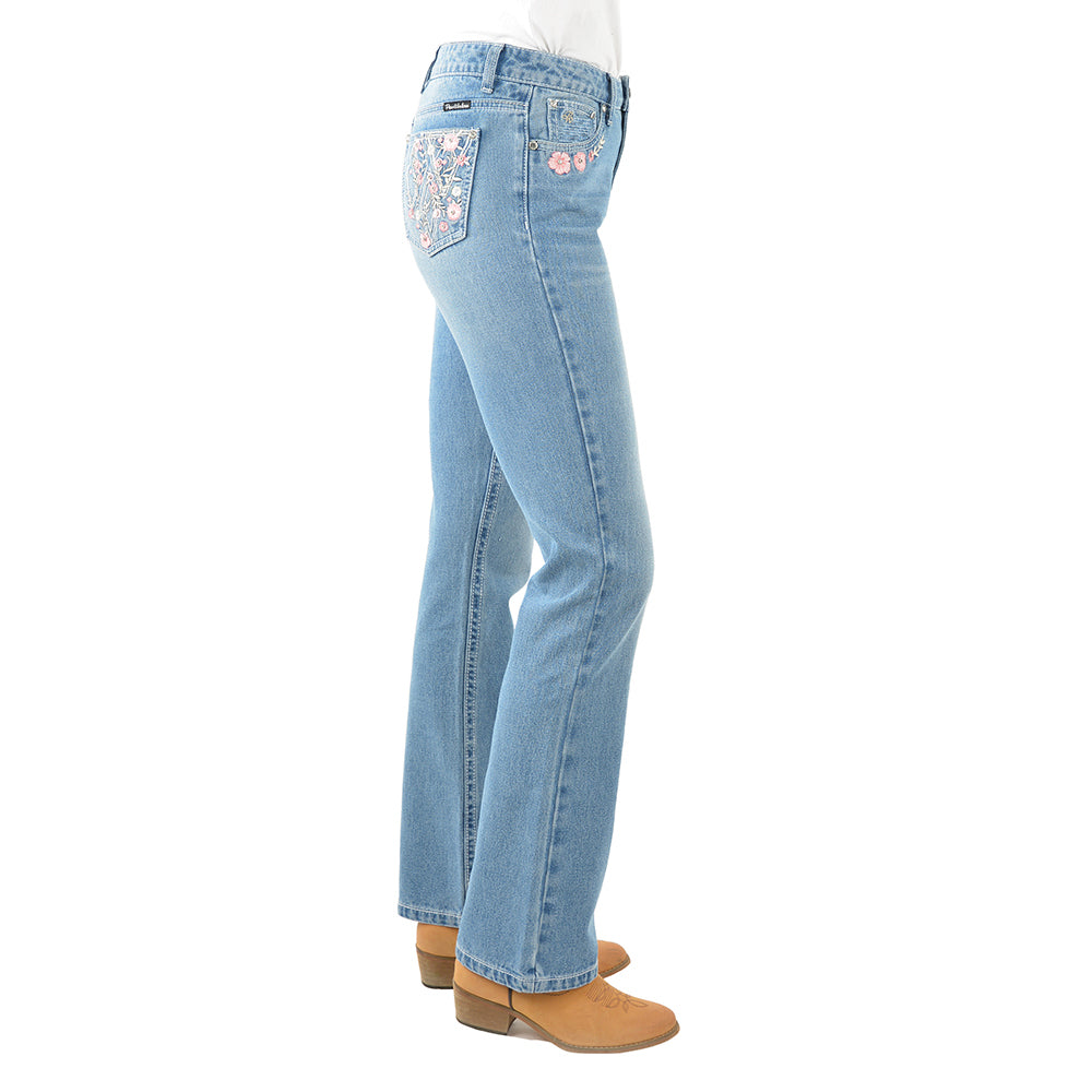 Side view of a pair of light blue denim Pure Western High Rise Flora Bootcut Jeans (PCP2213725) with floral embroidery on the pockets, worn by a model with brown heels against a white background.
