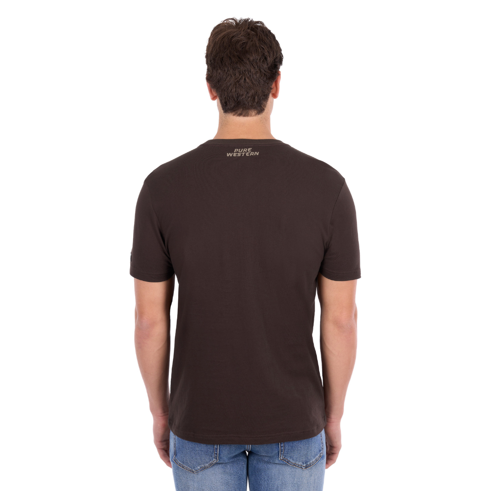 A man wearing a Pure Western Men's Tony Short Sleeve Tee (P6S1503313) in a Chocolate colour with denim jeans - back view.