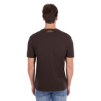 A man wearing a Pure Western Men's Tony Short Sleeve Tee (P6S1503313) in a Chocolate colour with denim jeans - back view.
