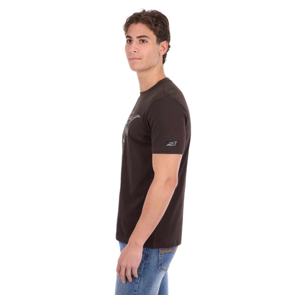 A man wearing a Pure Western Men's Tony Short Sleeve Tee (P6S1503313) in a Chocolate colour with denim jeans - side view.