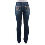 A person wearing Pure Western Womens Lola Bootcut Jeans - 34 Leg (PCP2208501) Midnight, with decorative stitching and patterned back pockets, shown from the waist down and viewed from the back.