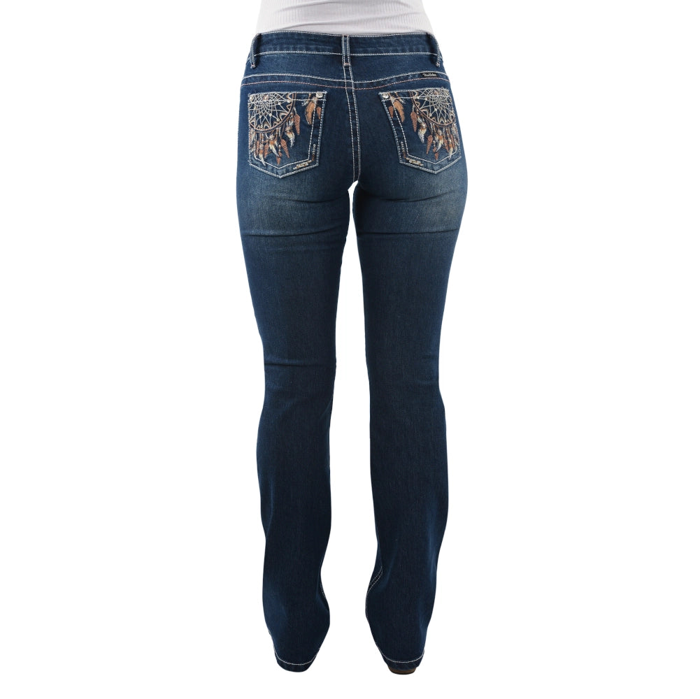 A person wearing Pure Western Womens Lola Bootcut Jeans - 34 Leg (PCP2208501) Midnight, with decorative stitching and patterned back pockets, shown from the waist down and viewed from the back.