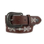 The Pure Western Womens Naomi Belt (P6W2934BLT) in Dark Tan features ornate white floral embroidery, an engraved antique silver buckle, and a decorative western concho on a brown leather strap.