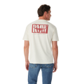 A man in blue jeans stands with his back to the camera, wearing the R.M.Williams Mens Branded S/S Tee (KDU10JE07) in white, featuring a large red "RMW THE ORIGINAL" logo on the back, against a plain white background.