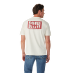 A man in blue jeans stands with his back to the camera, wearing the R.M.Williams Mens Branded S/S Tee (KDU10JE07) in white, featuring a large red "RMW THE ORIGINAL" logo on the back, against a plain white background.