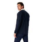 Man wearing a navy R.M.Williams Classic Shoulder Rugby and dark jeans on a white background. R.M.Williams Mens Classic Shoulder Rugby (KR200RJ4502) Navy