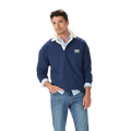 A man stands casually with one hand in his pocket, wearing the R.M.Williams Mens Mulyungarie 1/4 Zip Sweatshirt (KZU00BB03) in Vintage Blue over a light blue shirt and blue jeans, against a plain white background.