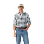 A man in a light baseball cap, blue jeans, brown belt, and an R.M.Williams Mens O'Connell Check L/S Shirt (SH201BS02) White stands with one hand in his pocket against a plain white background.