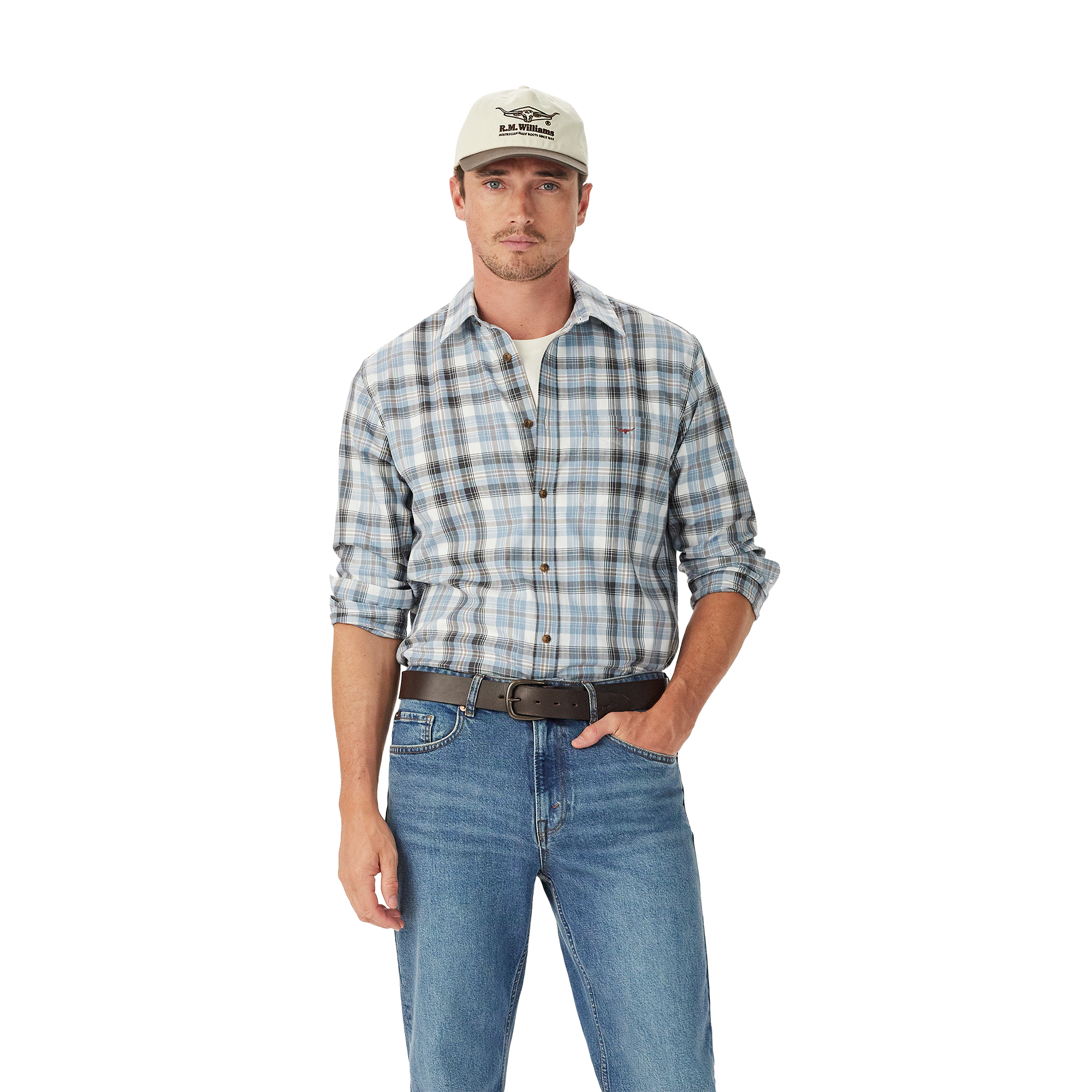 A man in a light baseball cap, blue jeans, brown belt, and an R.M.Williams Mens O'Connell Check L/S Shirt (SH201BS02) White stands with one hand in his pocket against a plain white background.