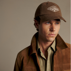 A man modelling an R.M.Williams Original RMW Heavy Twill Cap (ACX9OCT05) in Cinnamon.