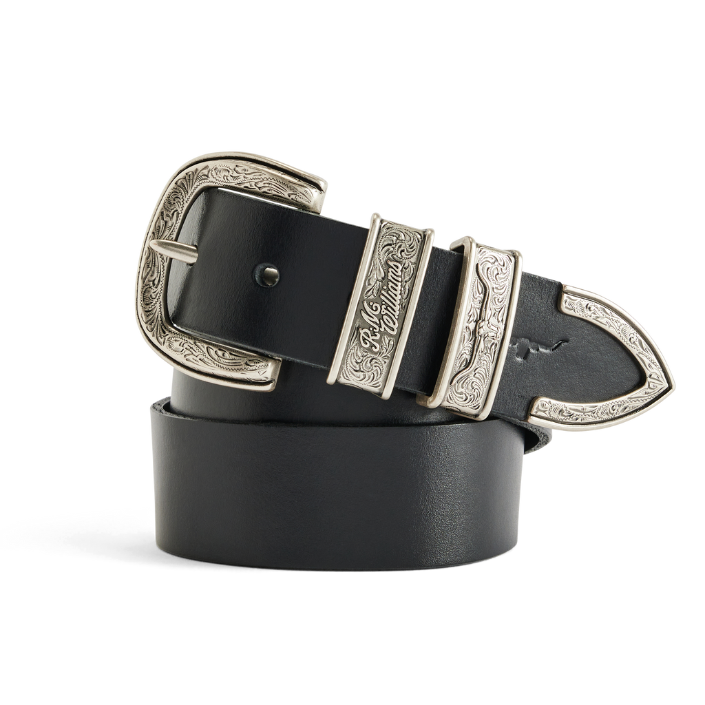 A coiled black R.M.Williams Western Drover Belt (BSF5DCH02) with engraved and embossed silver toned buckle, keepers and tail on a white background.