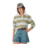 A woman wearing the R.M.Williams Womens Narran Stripe Rugby (KRR00RJ01) in Lichen stands with one hand on her hip against a plain white background.
