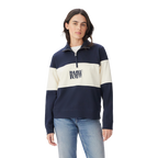 A person wears the R.M.Williams Womens Trickett Panel Sweatshirt (KZR00BB01) in French Navy, featuring navy and white colorblocking with "DRAW REV" text, paired with light blue jeans against a plain white background.