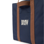 Close up detail of a navy R.M.Williams Heritage Tote (CGM9OCA04) with brown handles and RMW logo on a white background.