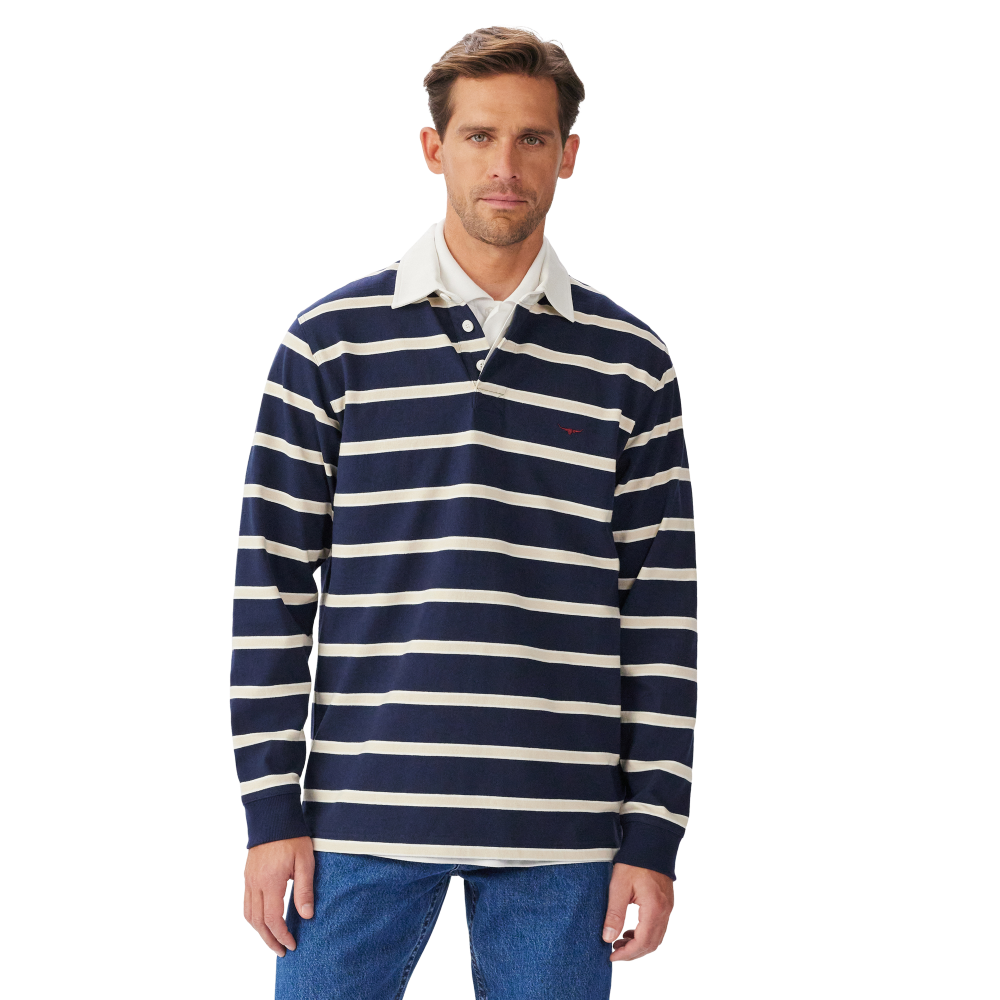 A man wearing a navy and sand R.M.Williams Men's Brunswick Rugby (KR200RJ12) with a white collar on a white background.