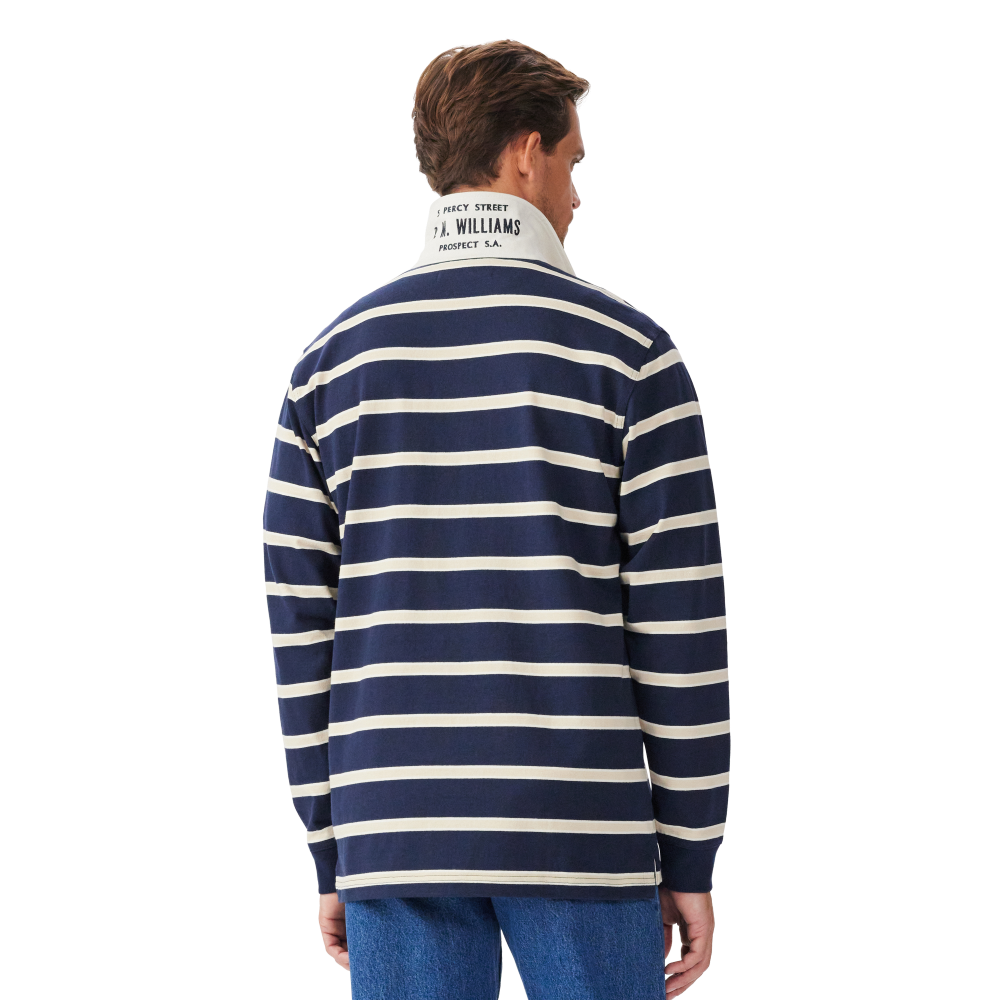 A man viewed from behind wearing a navy and sand R.M.Williams Men's Brunswick Rugby (KR200RJ12) with a white collar on a white background.