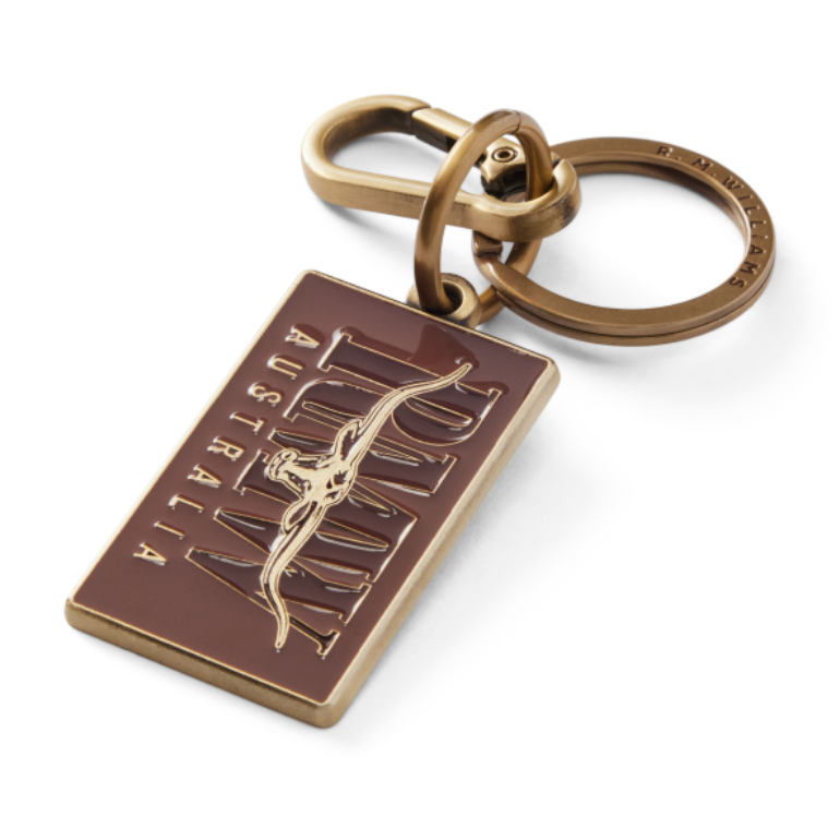 R.M.Williams Men's Heritage Logo Enamel Keyring (CKS4AMT01) with a brass clasp and a brown enamel tag featuring 'R.M. Williams Australia' on a white background.