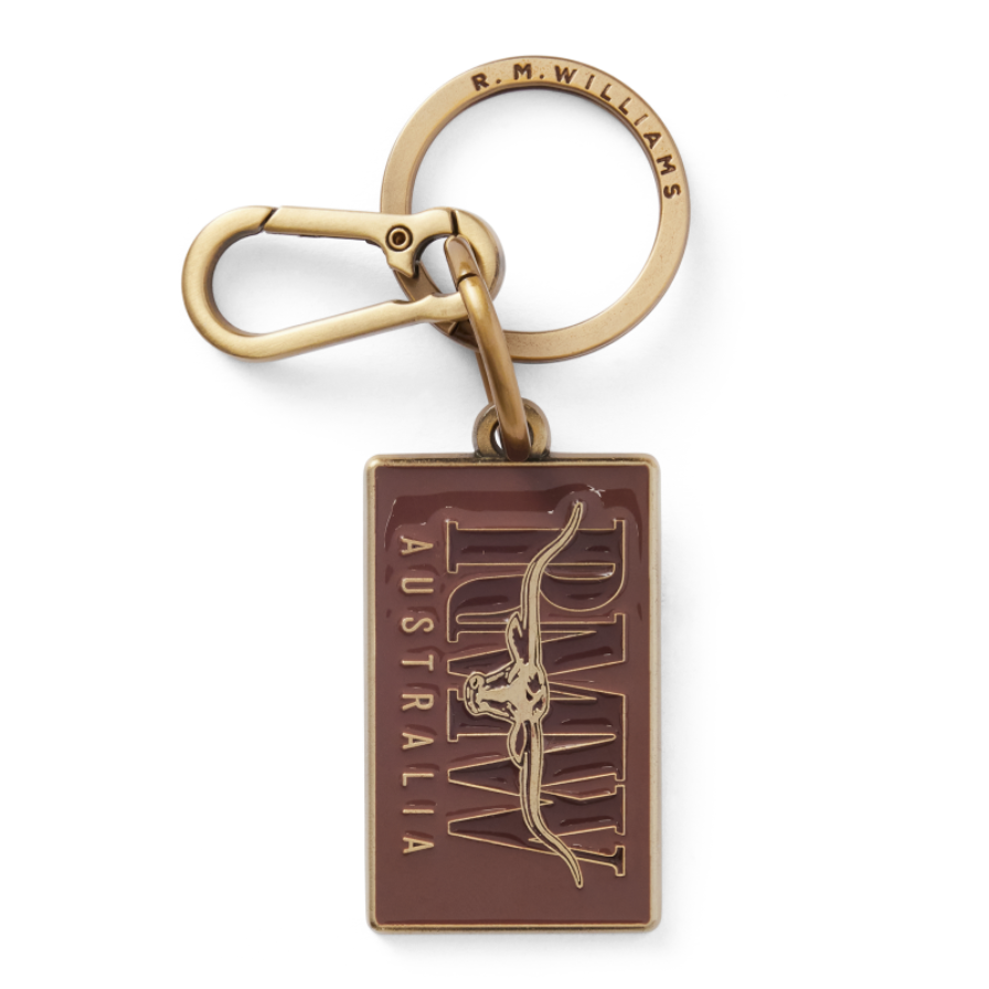 R.M.Williams Men's Heritage Logo Enamel Keyring (CKS4AMT01) with a brass clasp and a brown enamel tag featuring 'R.M. Williams Australia' on a white background.