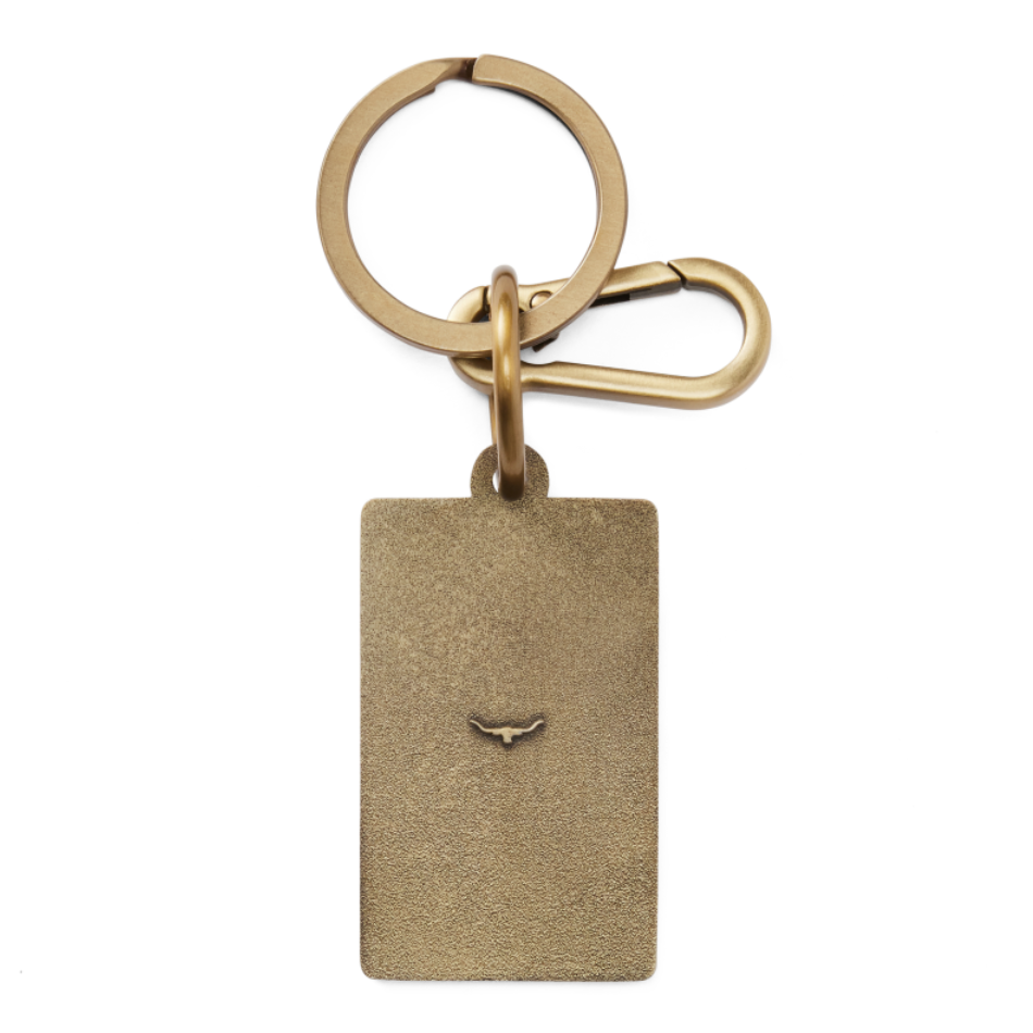 A back view of an R.M.Williams Men's Heritage Logo Enamel Keyring (CKS4AMT01) with a brass clasp on a white background.