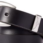 Close up detail of a black R.M.Williams Women's Cate Stitched Belt (BSC5FLE01) with a silver buckle on a white background.