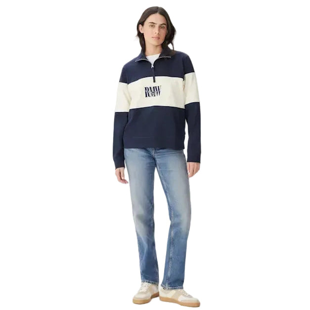 A woman modelling a navy and ivory R.M.Williams Women's Trickett Panel 1/4 Zip Jumper (KZ800RJ01) with an RMW's logo on a white background.