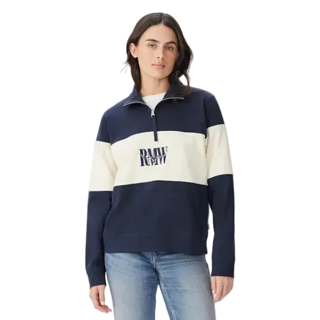 A woman modelling a navy and ivory R.M.Williams Women's Trickett Panel 1/4 Zip Jumper (KZ800RJ01) with an RMW's logo on a white background.