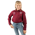 A young girl with blonde hair in a ponytail wears a Ringers Western Childrens Jackaroo Full Button L/S Work Shirt in burgundy with white embroidery and light blue jeans, smiling at the camera against a white background.